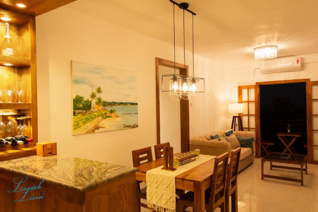 a living room with a table and a couch at Lavish Livin’ in Galle
