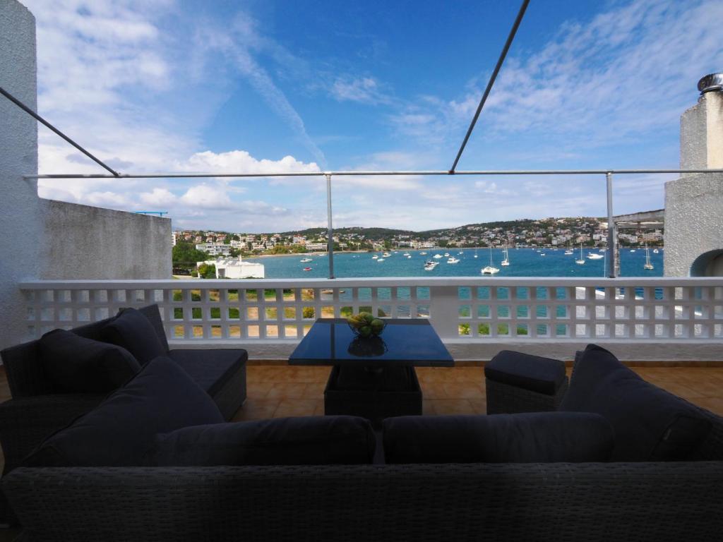 a living room with a couch and a view of the water at Sea Front Sophia Porto Rafti in Porto Rafti
