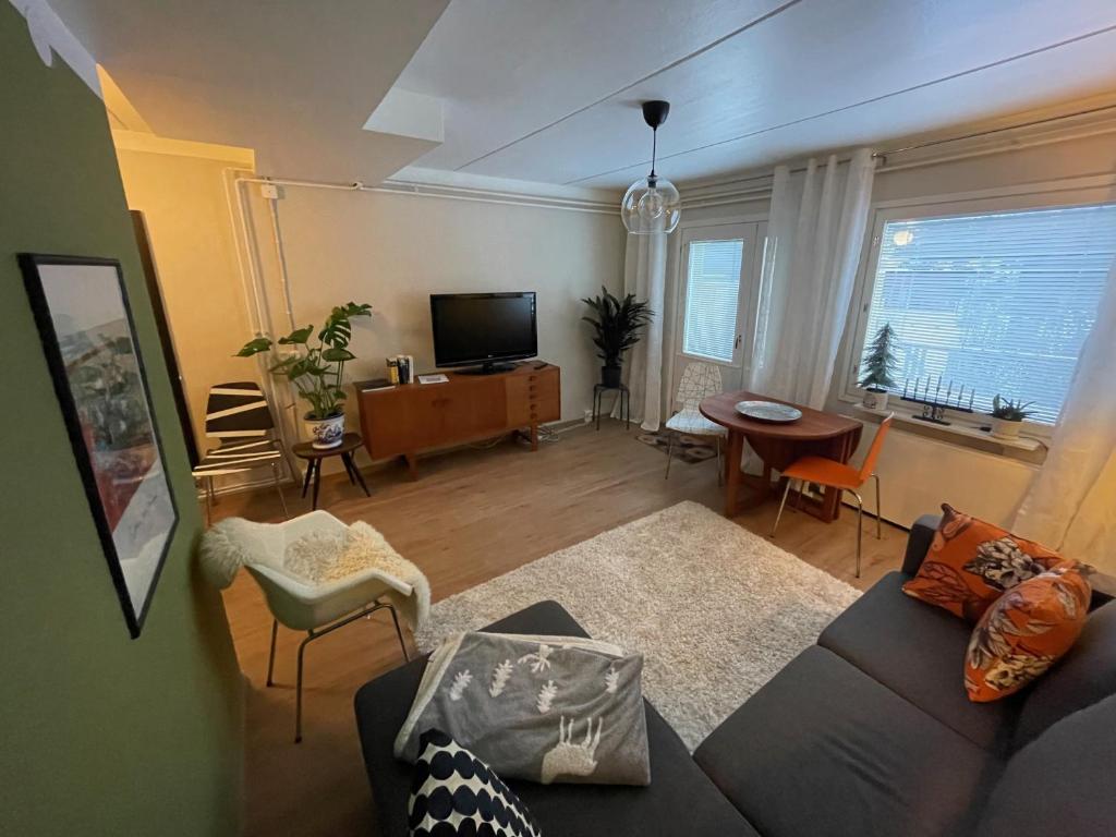 a living room with a couch and a table at Spacious city apartment in Rovaniemi