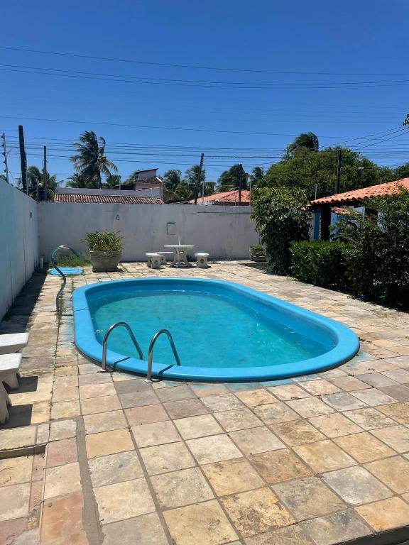 uma grande piscina azul num quintal em Casa inteira na Praia do Frances em Marechal Deodoro