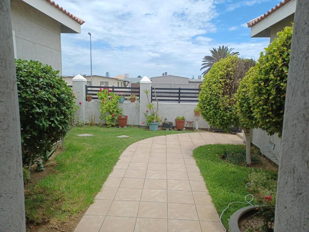 a walkway in the yard of a house at Carlo's Boutique Guesthouse in Walvis Bay
