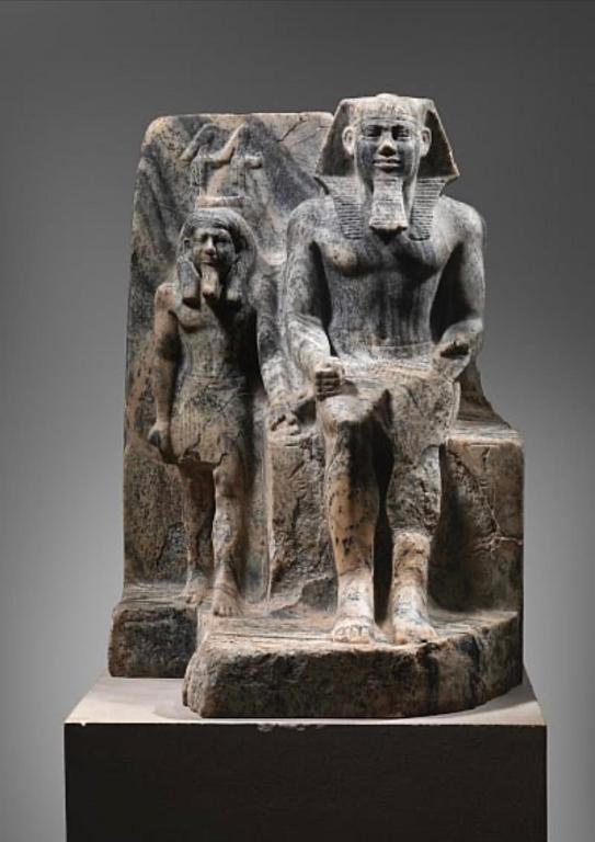 a statue of two people standing on a pedestal at Sahure Pyramid View Inn in Cairo