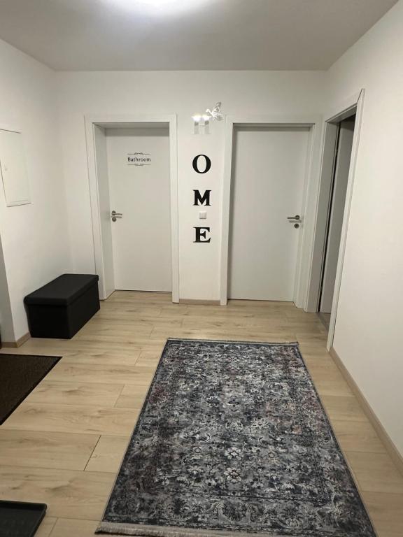 a hallway with two doors and a rug on the floor at Ferienwohnung Niederthalheim 