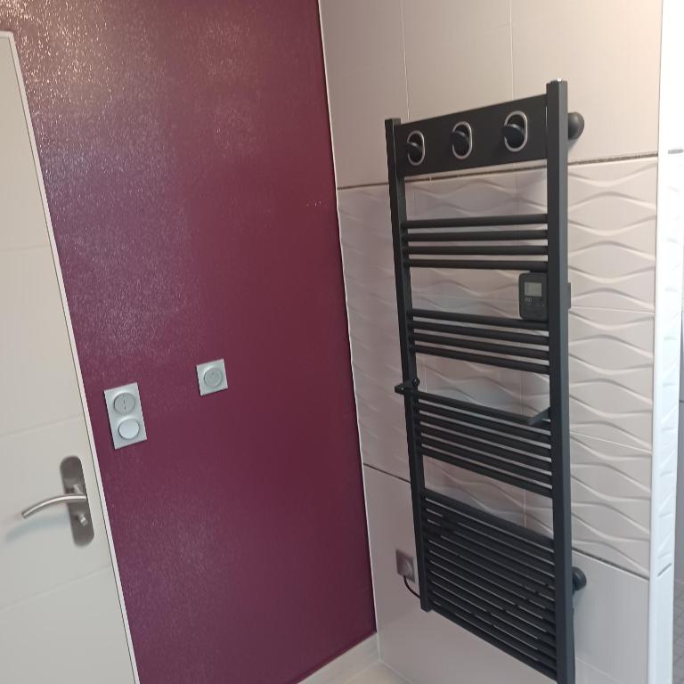 a bathroom with a door and a rack of shelves at Maison calme&#47;Chambre privée&#47;Clim+TV&#47;Pétit dejeuner inclu&#47;tout confort in Nevers