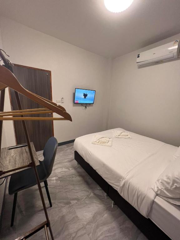 Postel nebo postele na pokoji v ubytování คีรีศิลป์ รีสอร์ท เชียงราย (Khirisin Resort Chiang rai)