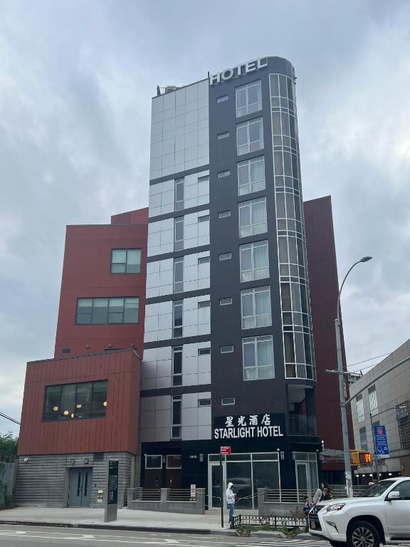 Hotel Starlight Hotel Near LGA Airport, a tall building with a sign on the front of it at Starlight Hotel Near LGA Airport in Queens