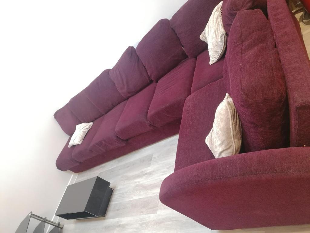 a living room with a red couch at Great Home of Relaxations in Stoke on Trent