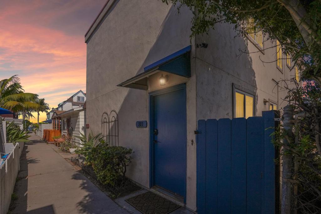 a blue door on the side of a house at Mission Bay Condo - Steps to Sand, Dining, AC, Parking & Shops! in San Diego
