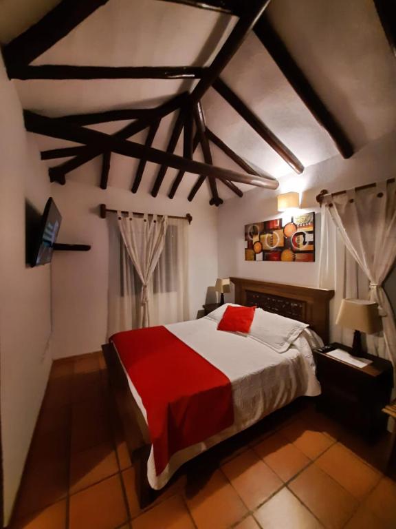 Postel nebo postele na pokoji v ubytování Aparta Hotel El Refugio de María