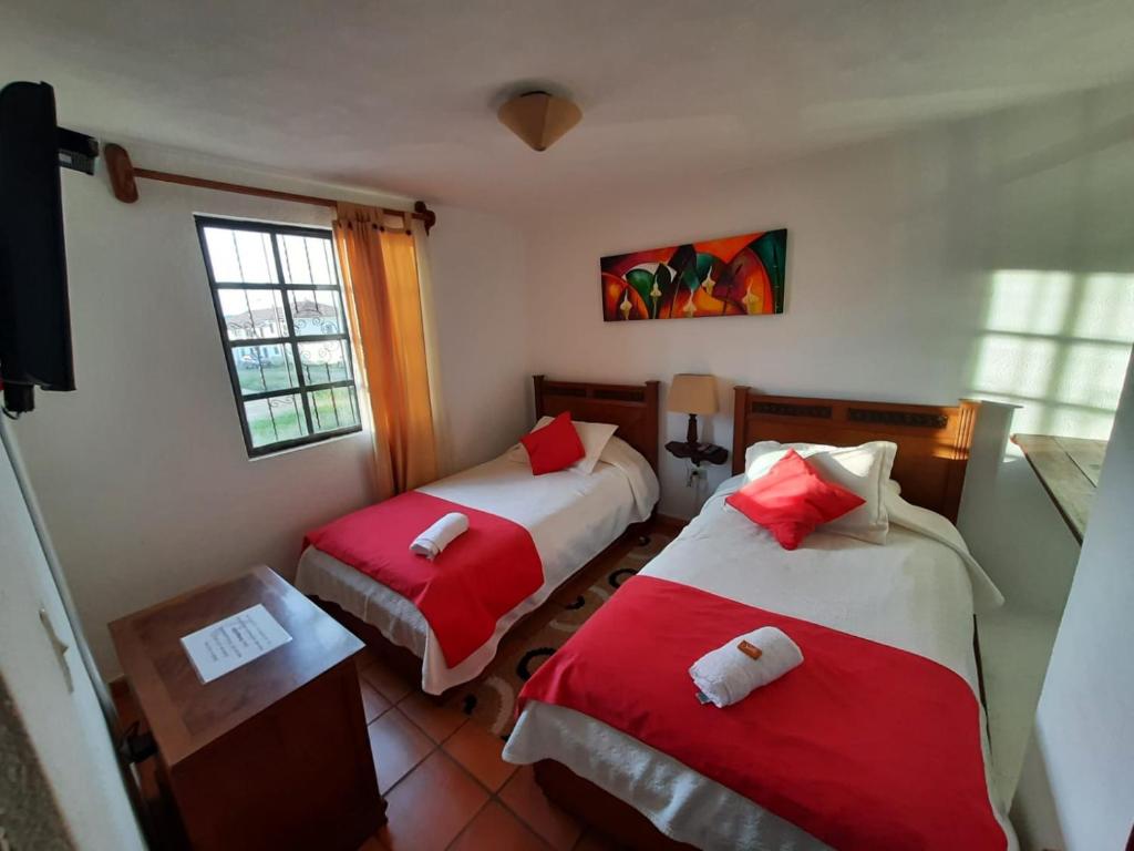 Postel nebo postele na pokoji v ubytování Aparta Hotel El Refugio de María