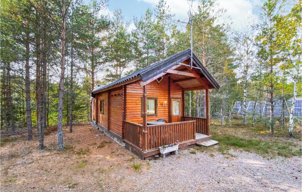 a log cabin in the woods with trees at Stuga 1 in Nybro