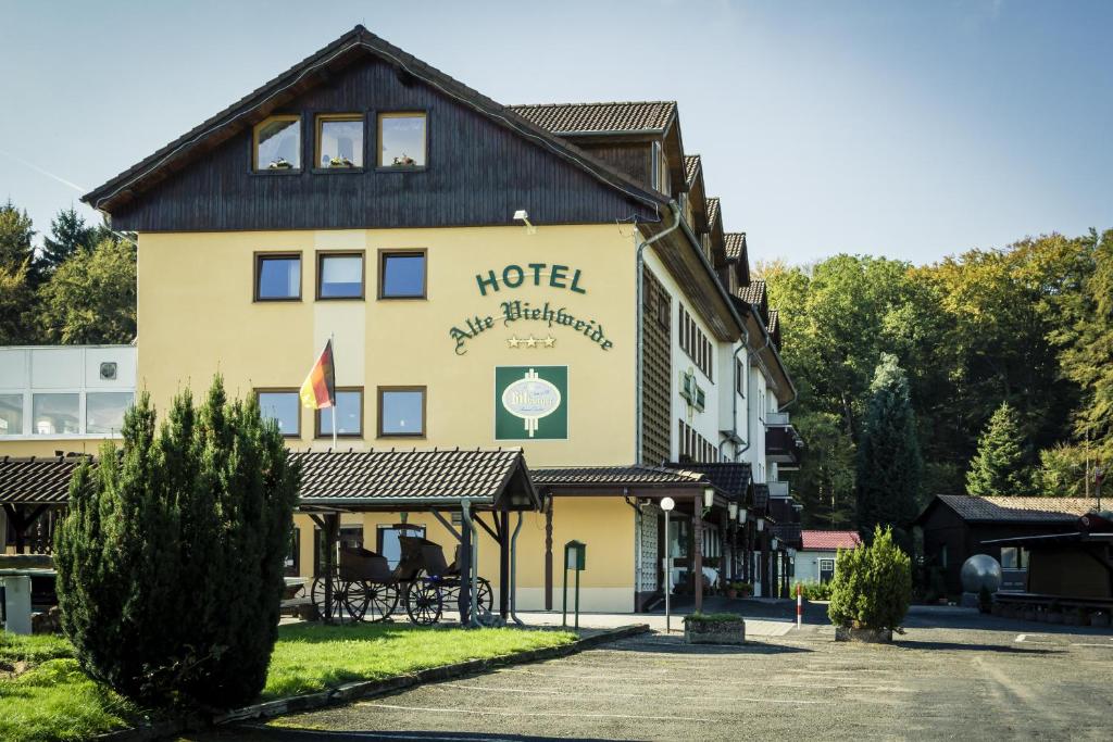 a hotel with a sign on the side of a building at Hotel Alte Viehweide in Helferskirchen