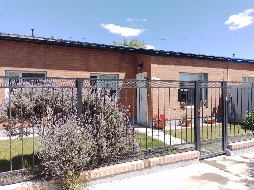 a fence in front of a brick building at Las Lavandas ´´Casa de Playa´´ in Playa Unión