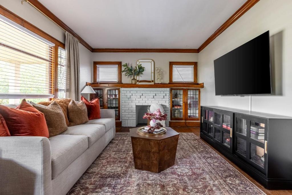 a living room with a couch and a flat screen tv at Stunning 3BR - Near Cleveland Clinic Main Campus in Cleveland Heights