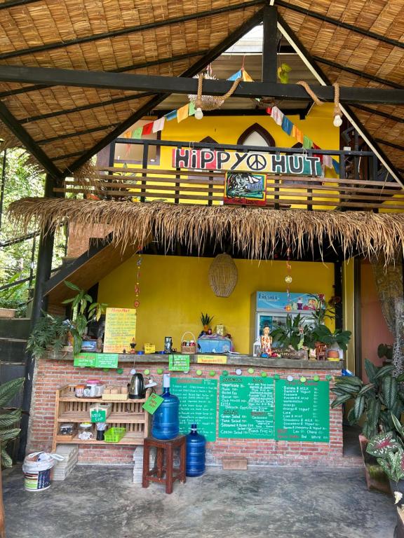 a fast food restaurant with a happy hunk restaurant at Hippy Hut Koh Chang in Ko Chang