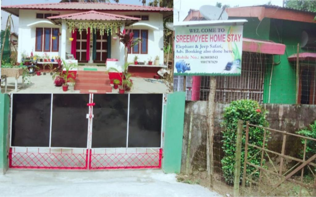 una casa con una puerta y un cartel delante de ella en SREEMOYEE HOMESTAY, en Hatikhuli