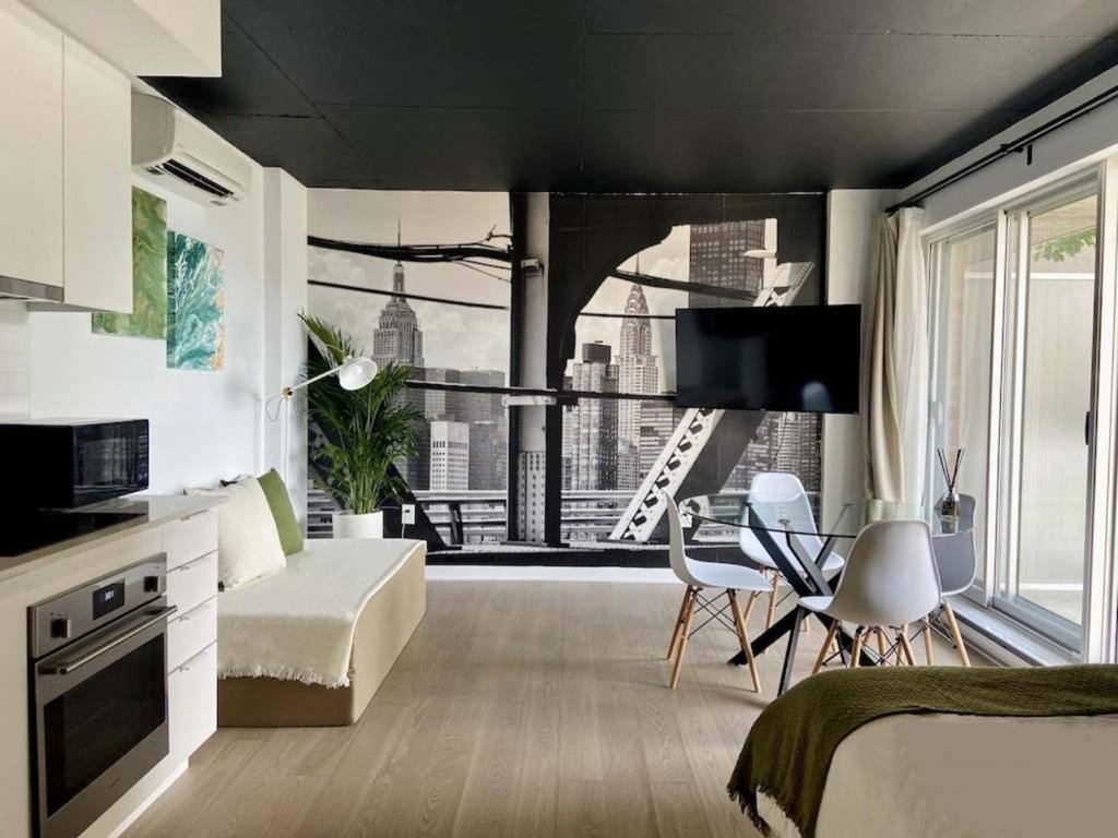 a living room with a view of a city at Appartement condo avec terrasse privée dans le Quartier des Spectacles in Montréal