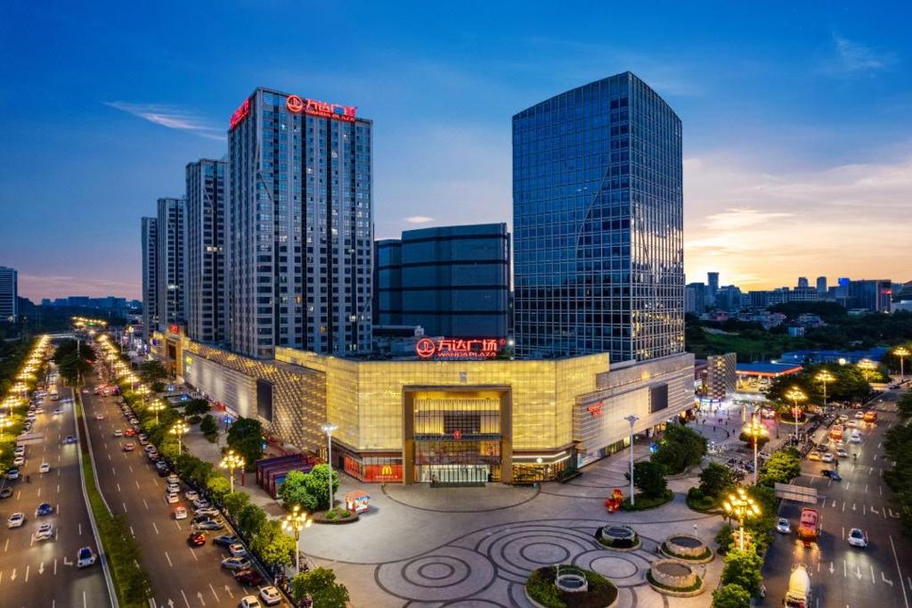 a city with tall buildings and a street with traffic at Livetour Hotel Luogang Wanda Plaza Suyuan Metro Guangzhou in Guangzhou
