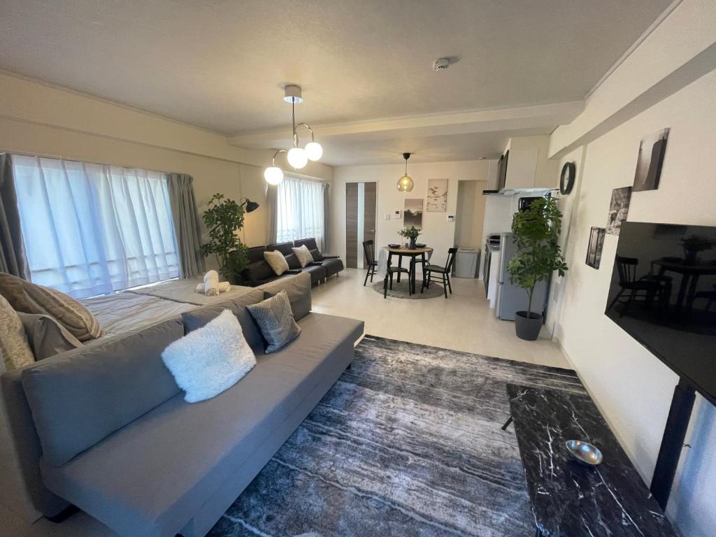 a living room with a couch and a table at Oak Stay Shimokitazawa Luxury Family size 2min Shimokitazawa sta Shinjuku Shibuya7min by train in Tokyo