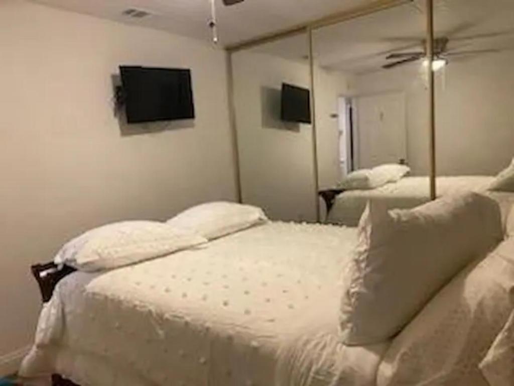 a bedroom with a white bed with a mirror at Private Room in Rialto