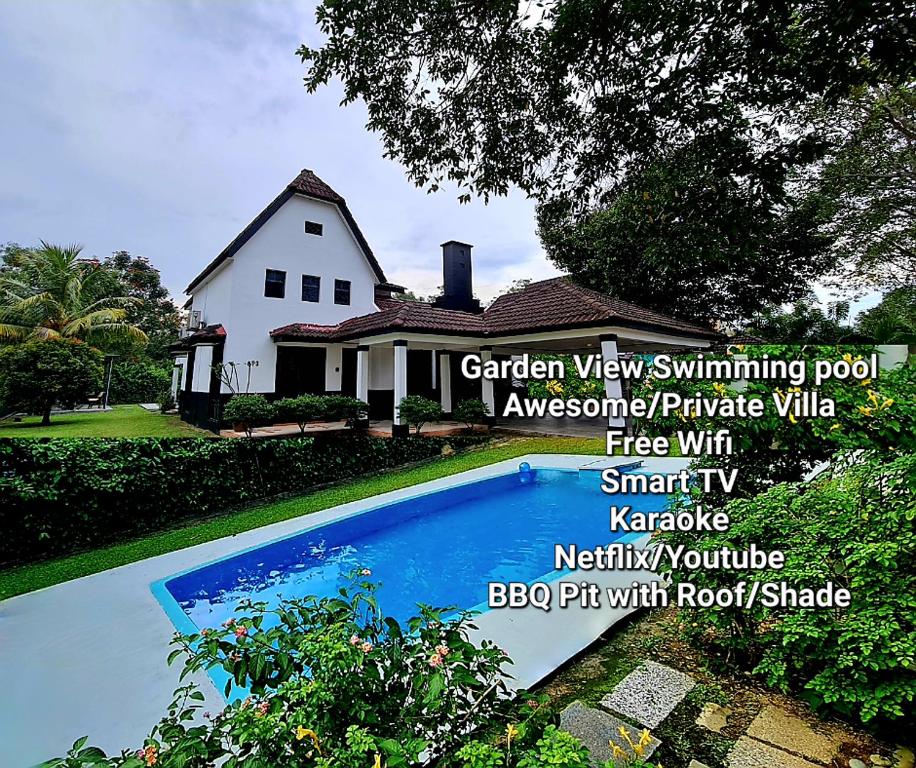 a house with a swimming pool in front of a house at Private 4Bedroom Villa Pool,BBQ,Karaoke, Afamosa Resort in Kampong Alor Gajah