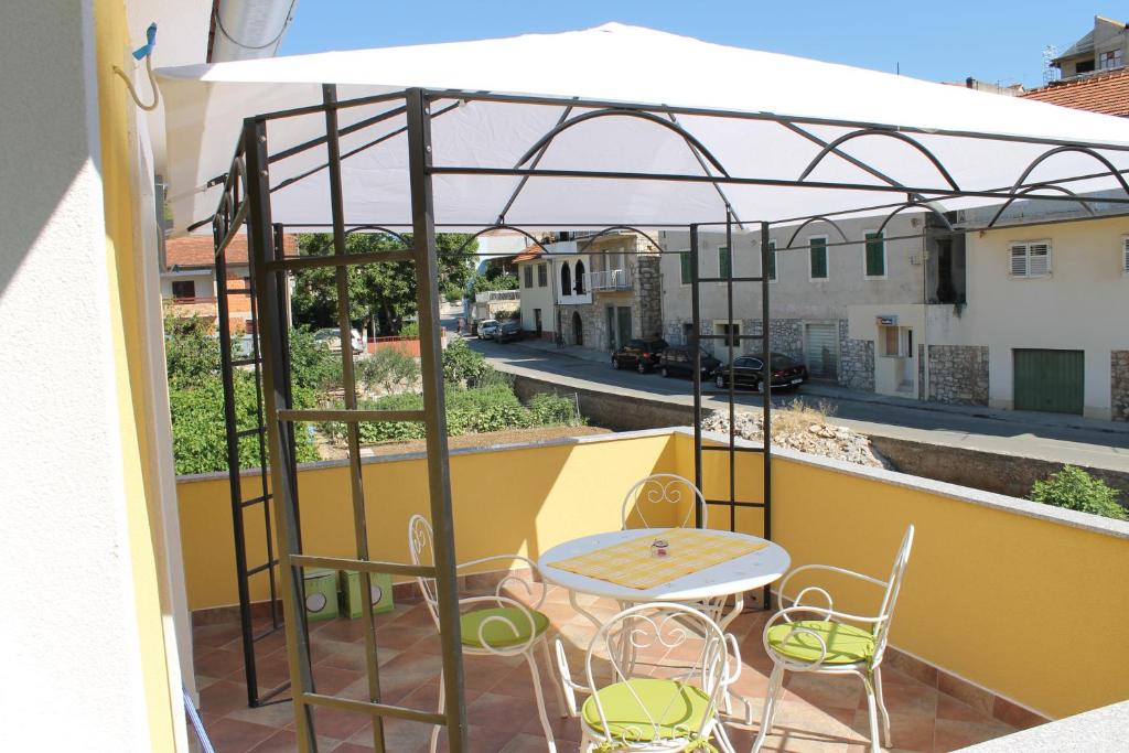 a patio with a table and chairs on a balcony at Apartment Antić in Zaton