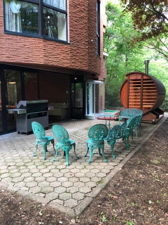 a group of chairs and a table on a patio at 最大２２名BBQ.サウナ.カラオケ.ビリヤード.卓球付き! in Nasu-yumoto