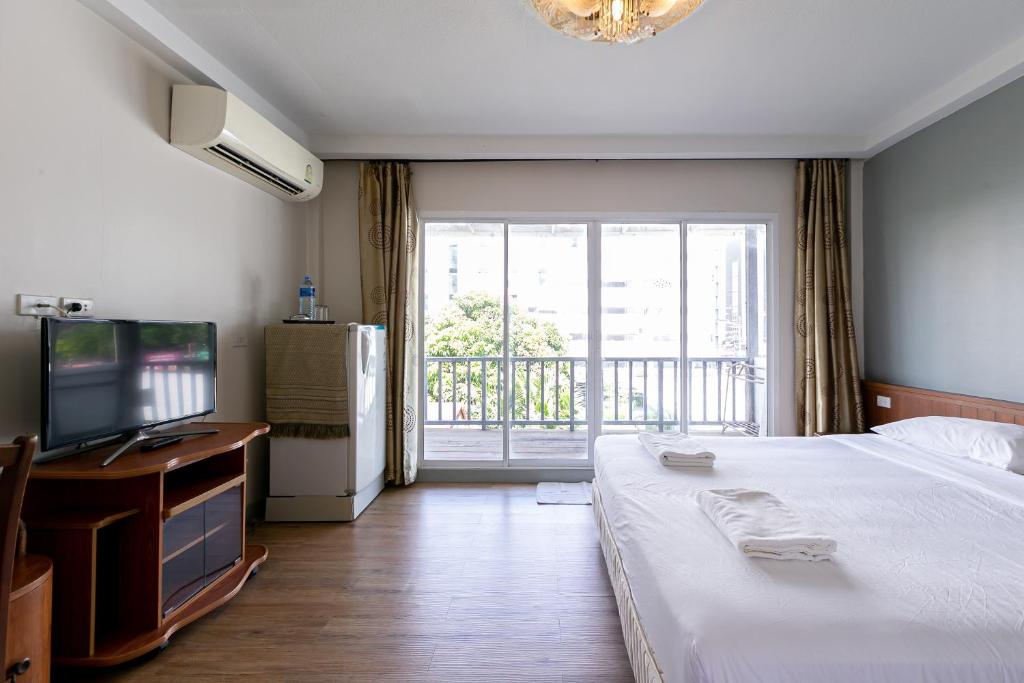 Postel nebo postele na pokoji v ubytování Wong Amat House