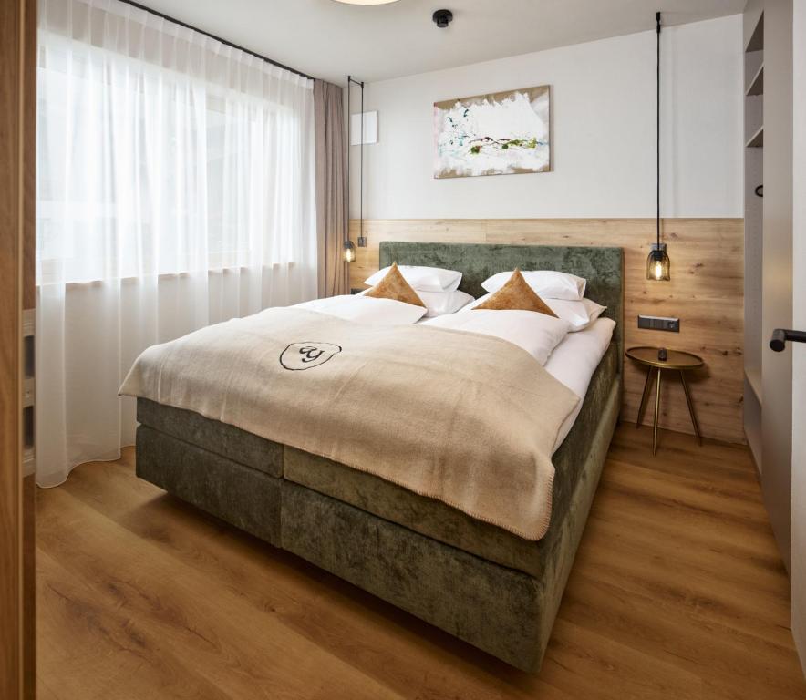 1 dormitorio con 1 cama grande en una habitación en Apart Galeon, en Pettneu am Arlberg
