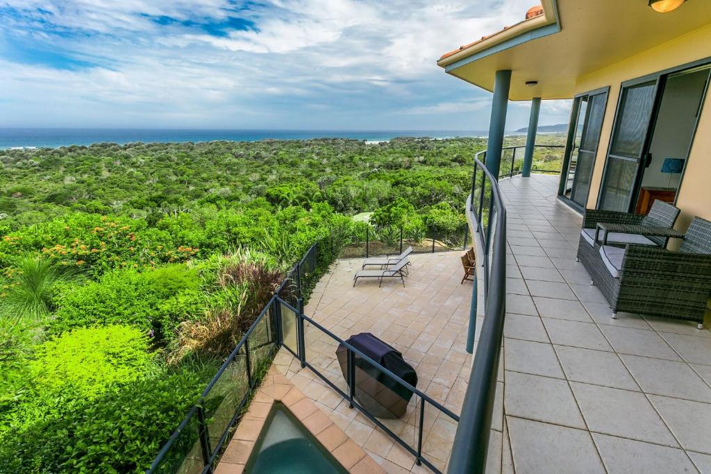a balcony of a house with a view of the ocean at A Perfect Stay - Above Byron in Byron Bay