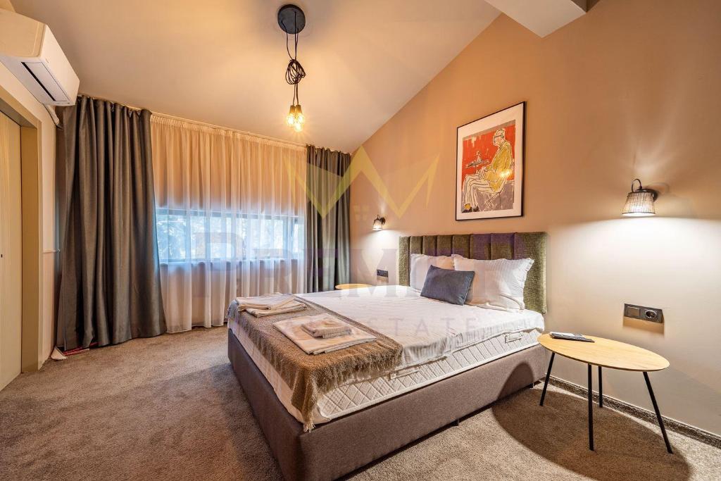 a bedroom with a large bed and a table at Casa Verde in Saints Constantine and Helena