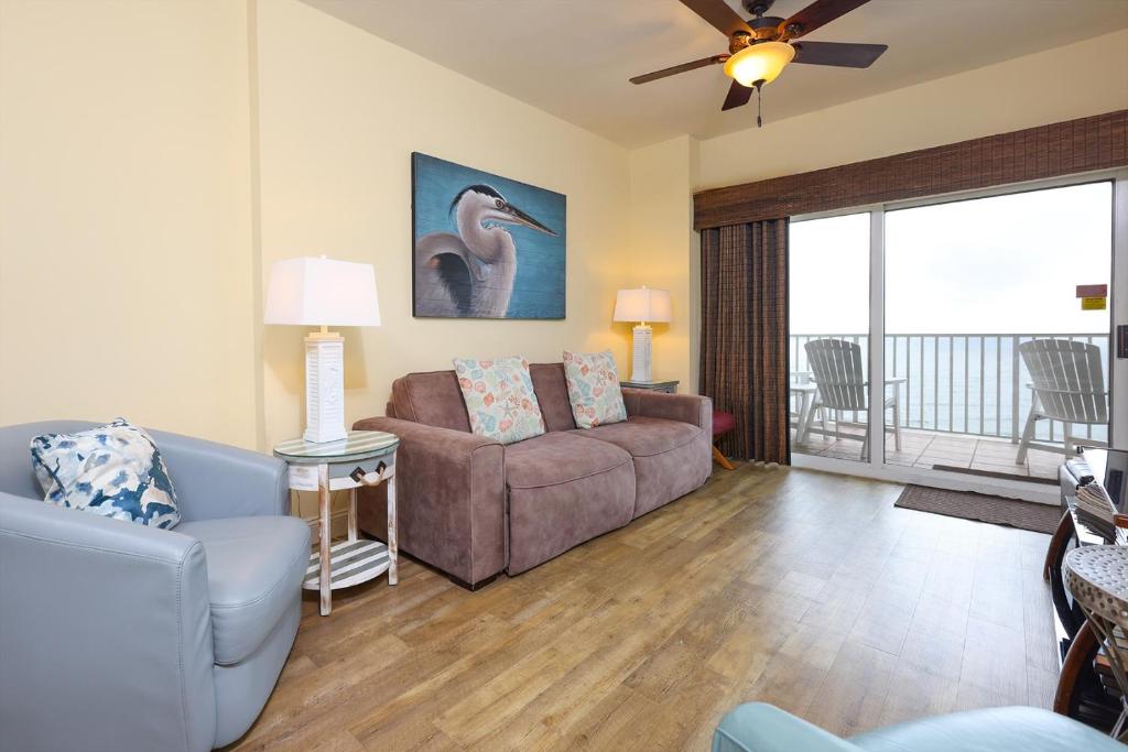 a living room with a couch and a chair at Tidewater 1202 condo in Orange Beach