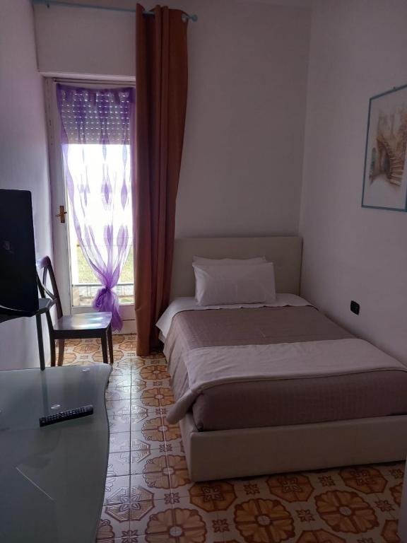 Postel nebo postele na pokoji v ubytování Il Brindisi di C & C Castelli Romani