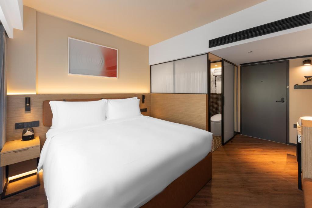Postel nebo postele na pokoji v ubytování Mia Hotel - Shanghai Xuhui Jiaotong University