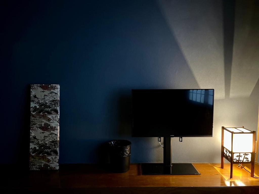 a flat screen tv on a blue wall at Yuzawa house in Yuzawa