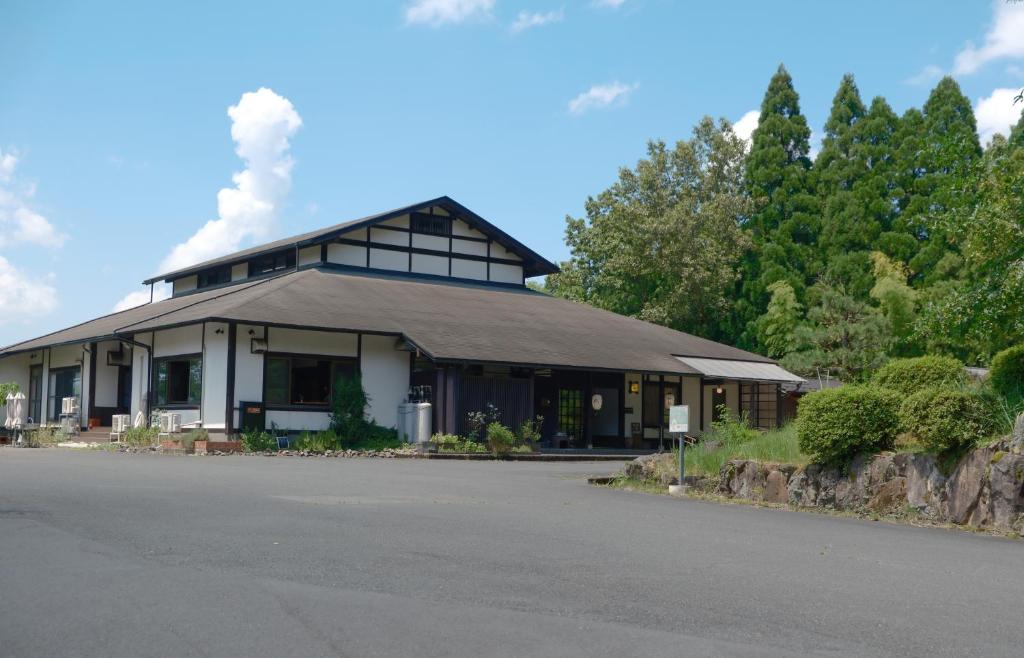 a building with a smoke stack on top of it at Kaya Yamanoie in Yosano