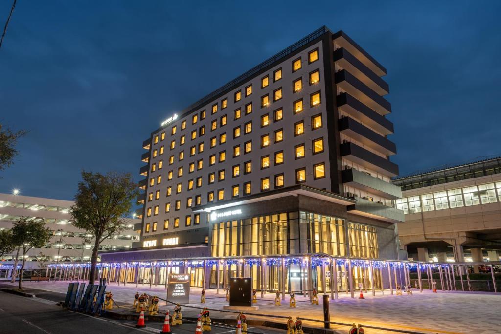 北上市SAKURA PORT HOTEL的一座前面有灯光的大楼