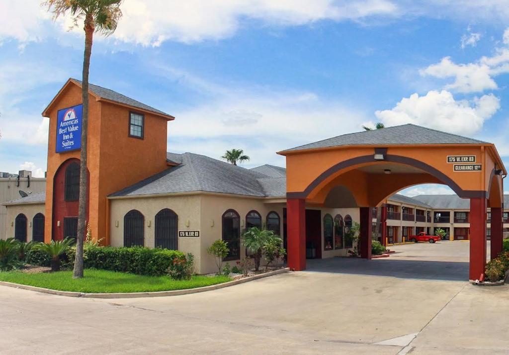 a building with an archway in front of a motel at Americas Best Value Inn & Suites San Benito in San Benito