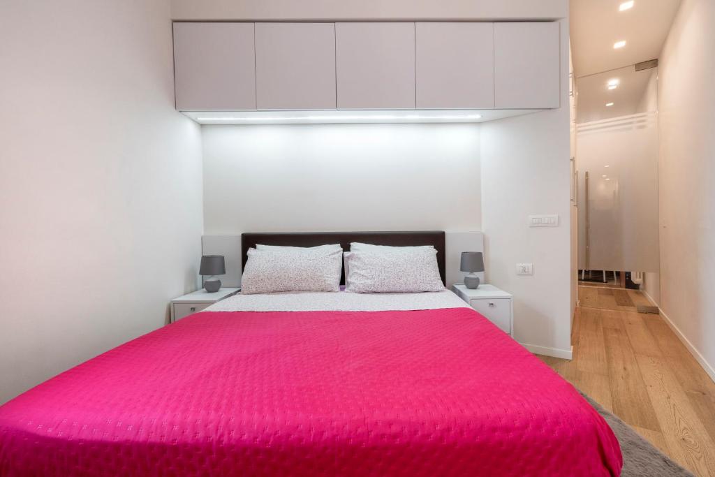 a bedroom with a large bed with a red blanket at Martini Matera 2-luxury apartment in Matera