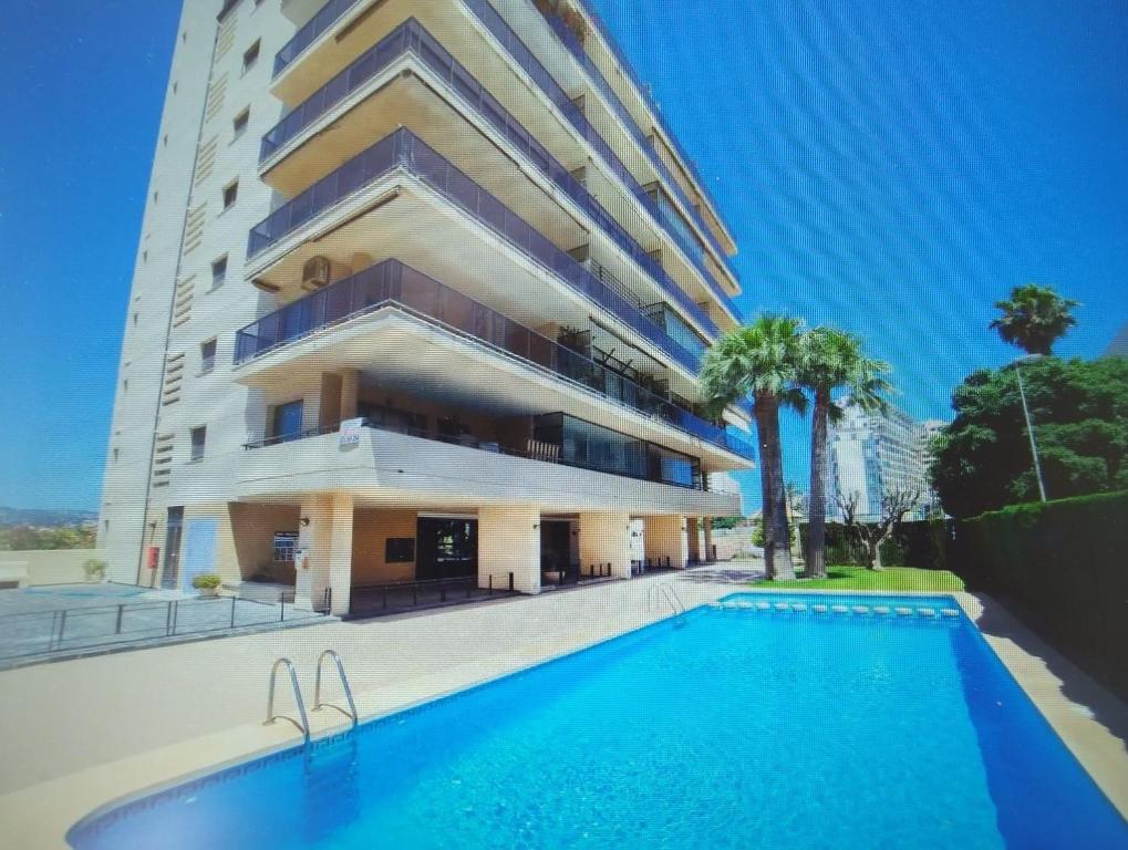 a building with a swimming pool in front of it at Morello 1A in Calpe