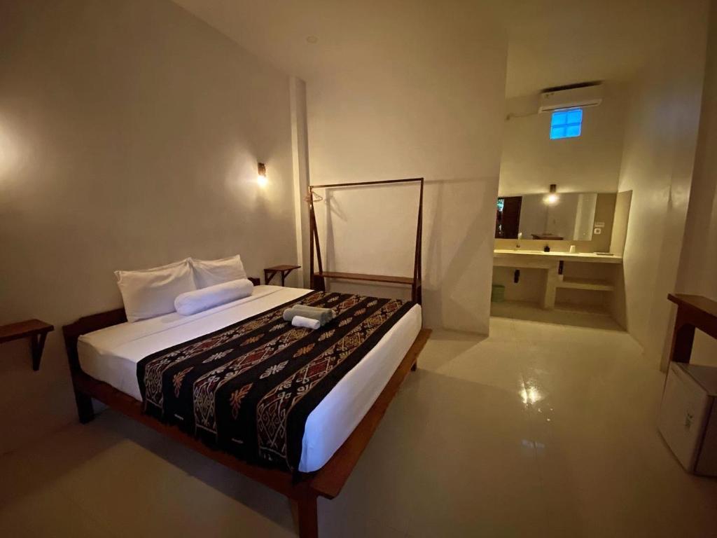 Postel nebo postele na pokoji v ubytování Mango Room Mandalika
