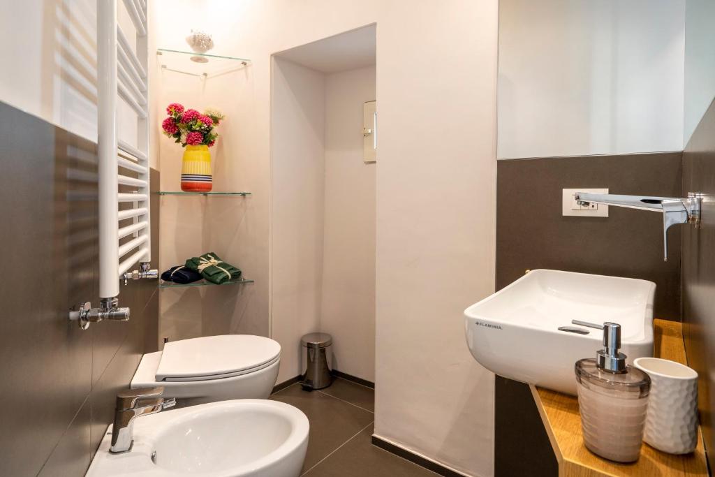 a bathroom with a white toilet and a sink at Martini Matera 2-luxury apartment in Matera