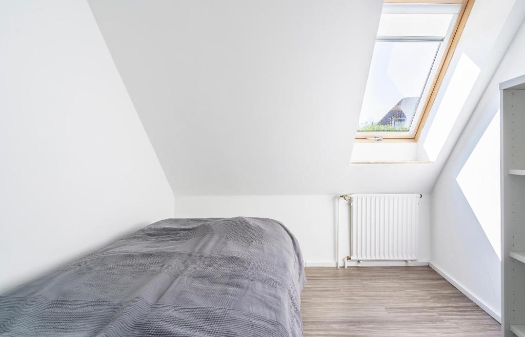Ce lit se trouve dans un dortoir blanc doté d'une fenêtre. dans l'établissement SummerBreak 1 Scharbeutz, à Scharbeutz
