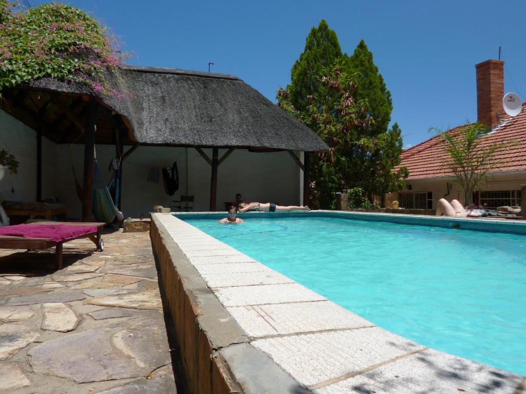 a person in a swimming pool in a house at ParadiseGarden Backpackers in Windhoek