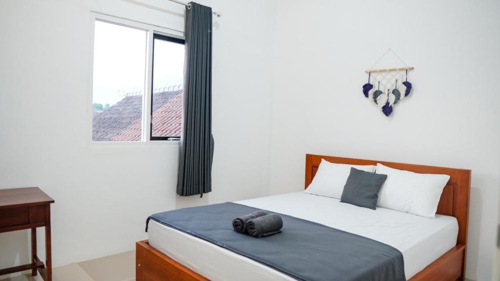 Postel nebo postele na pokoji v ubytování Wangi Homestay