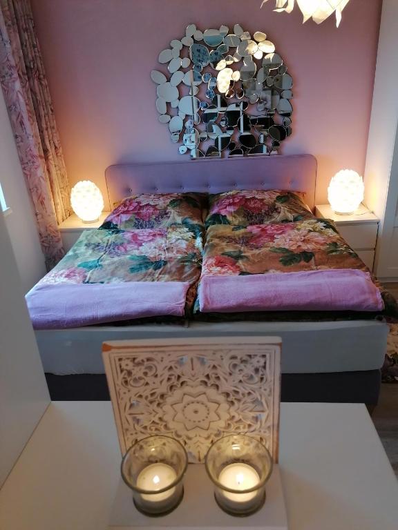 a bedroom with a bed with a mirror on the wall at Summer Wine romantisches, fahrradfreundliches Weinbergidyll mit Traumausblick gleich neben Buschenschank! in Leutschach