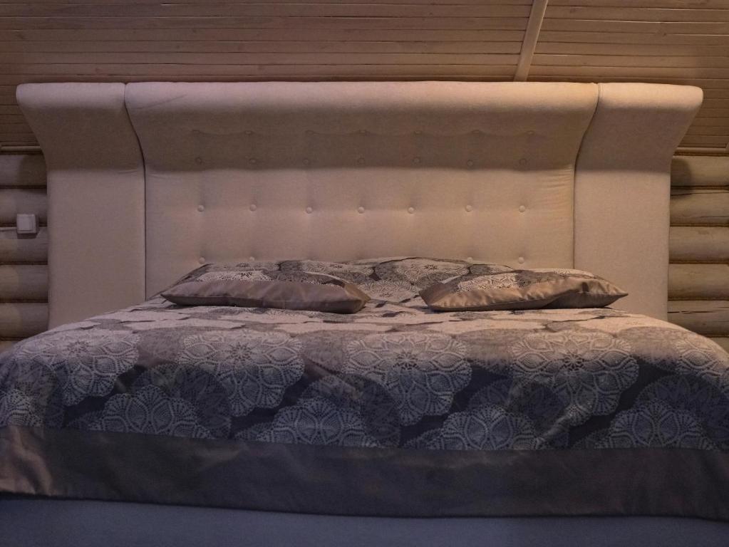 a bed with two pillows on top of it at Номер Стандарт 