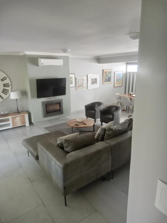 a living room with a couch and a table at Franschhoek - La Petit Village - CENTRAL in Franschhoek
