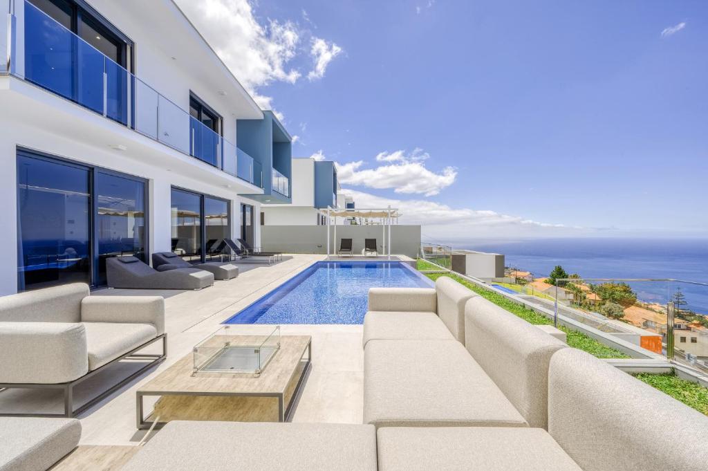 a villa with a swimming pool and a view of the ocean at Villa Boa Nova Verde by LovelyStay in Funchal