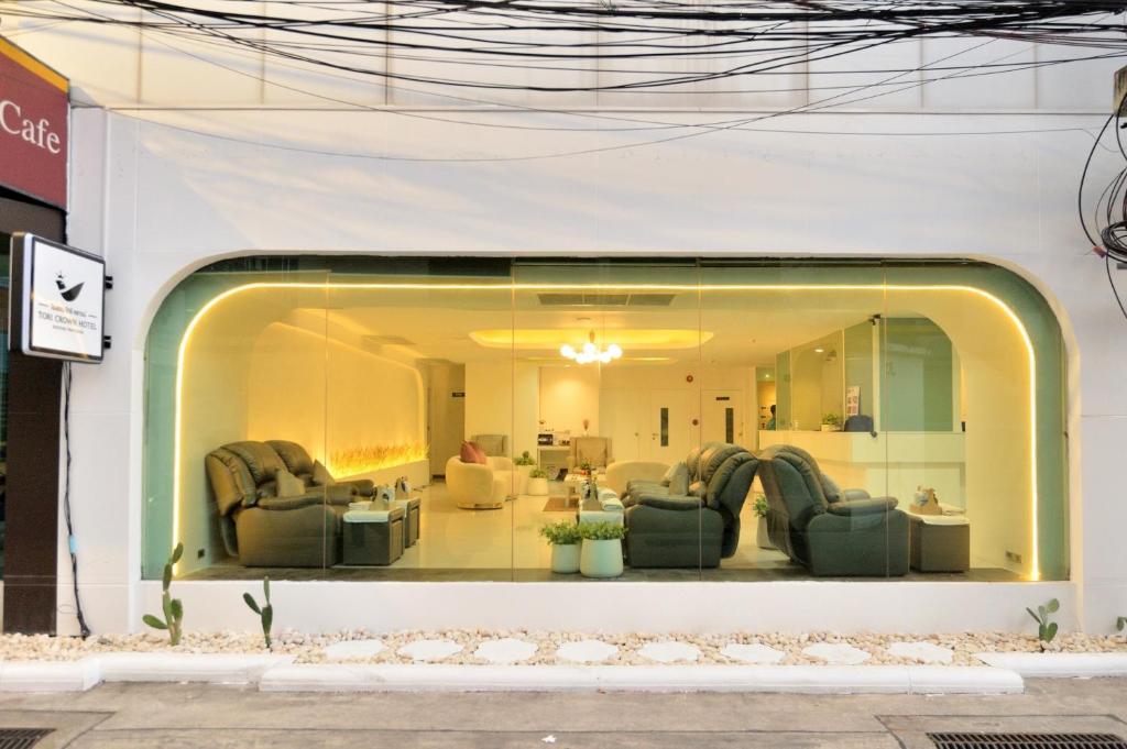a store window with couches in a living room at Tori crown hotel in Bangkok